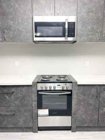 a stove top oven sitting inside of a kitchen