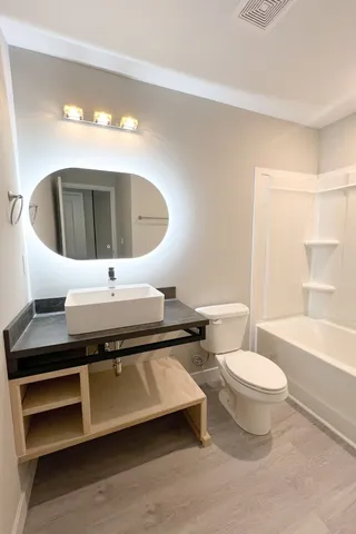 a bathroom with a toilet a sink and bathtub