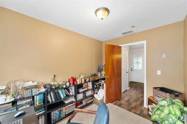 a view of a workspace with furniture and a window
