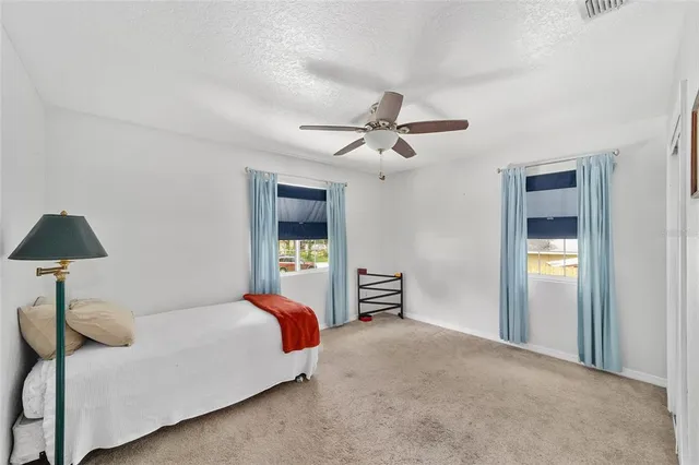a view of a room with wooden floor closet and ceiling fan