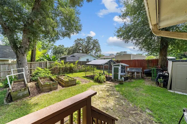 a view of backyard with deck and outdoor seating