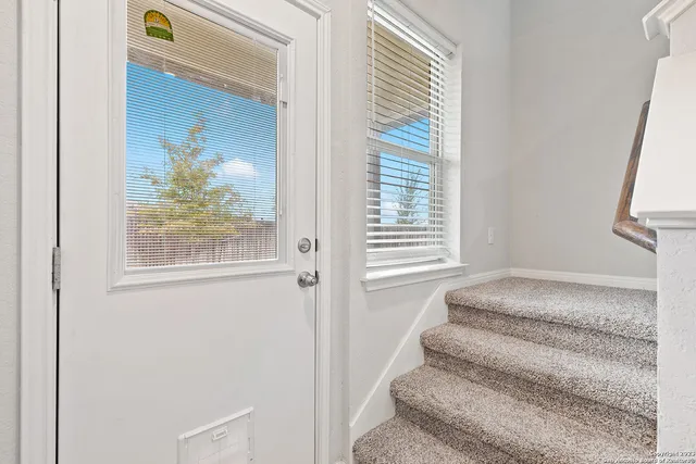 a view of bedroom with window and stairs