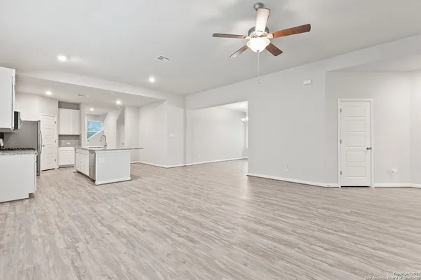 a view of kitchen with refrigerator stove and a cabinets