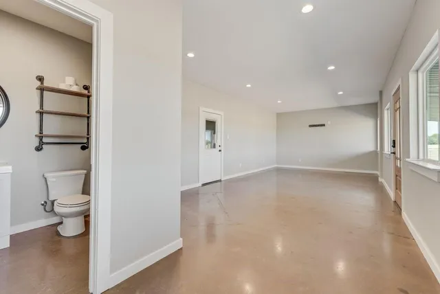 a bathroom with a toilet a sink and a mirror