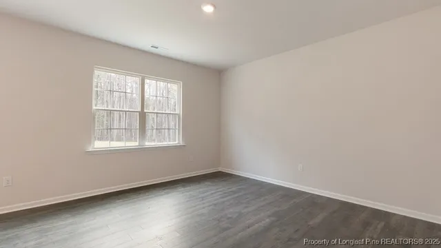 an empty room with a empty space and windows