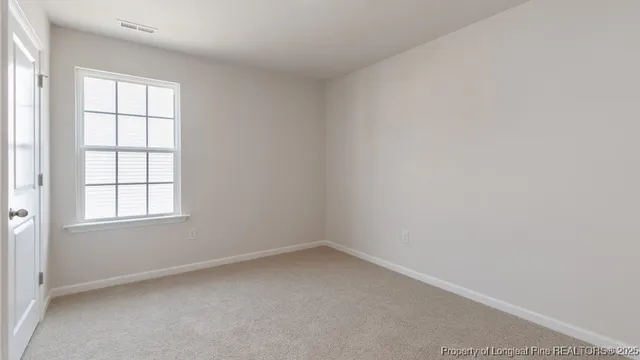 an empty room with closet area