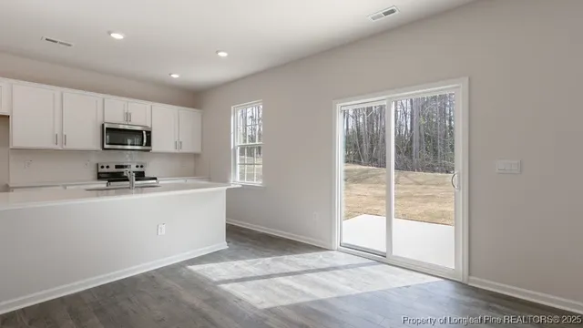 a kitchen with sink a microwave and cabinets