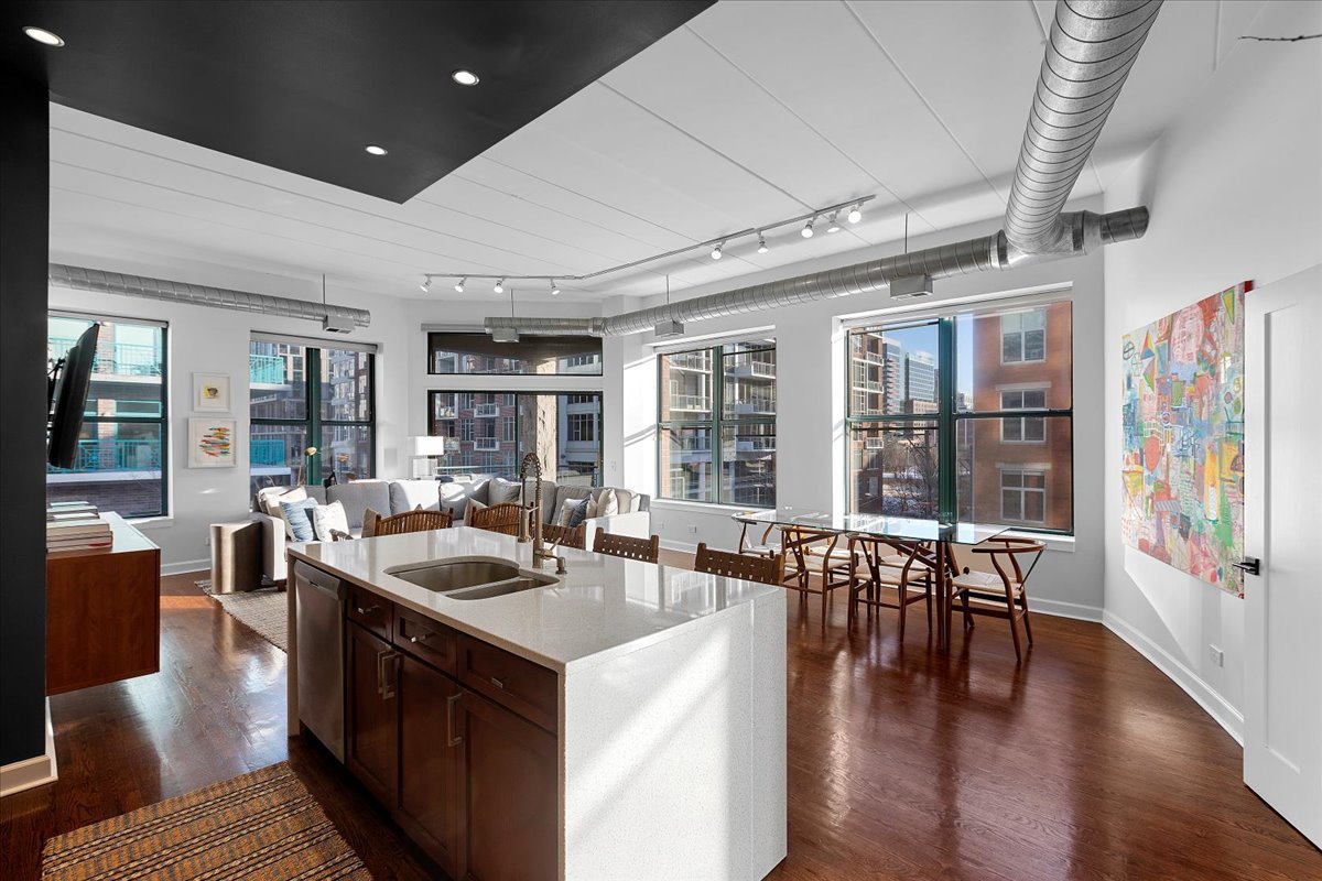 936 West Madison Street, Unit 4C Chicago, IL 60607 - Photo 2 of 16 a kitchen with a table chairs and wooden floor