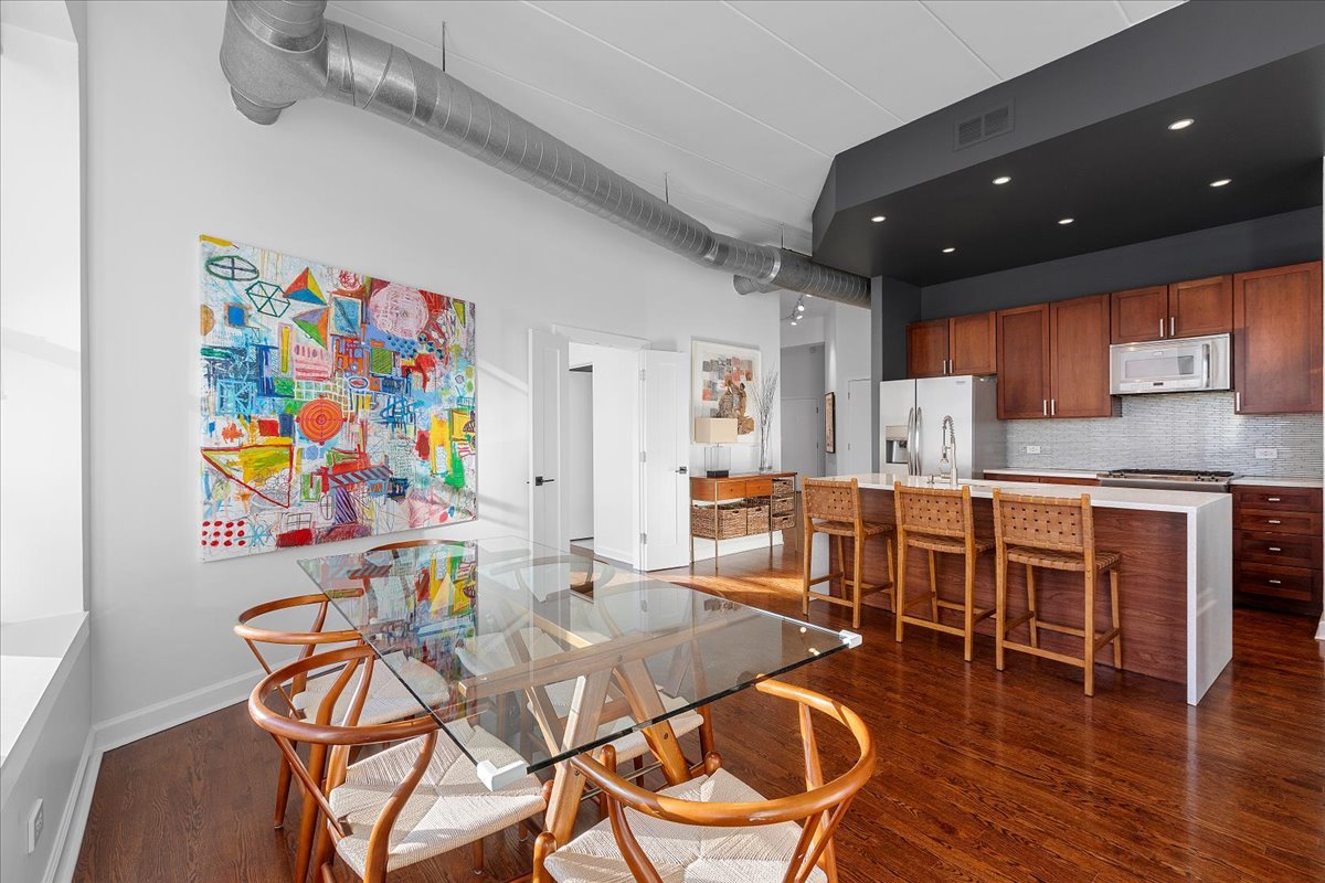 936 West Madison Street, Unit 4C Chicago, IL 60607 - Photo 5 of 16 a view of a dining room with furniture and wooden floor