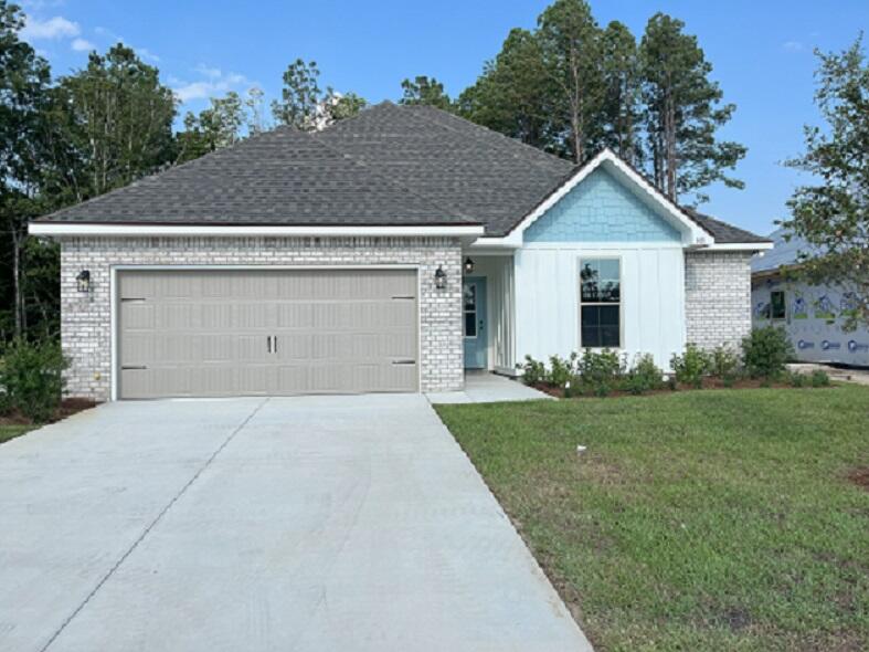 105 Eclipse Loop Freeport, FL 32439 - Photo 1 of 2 a front view of house with yard and green space