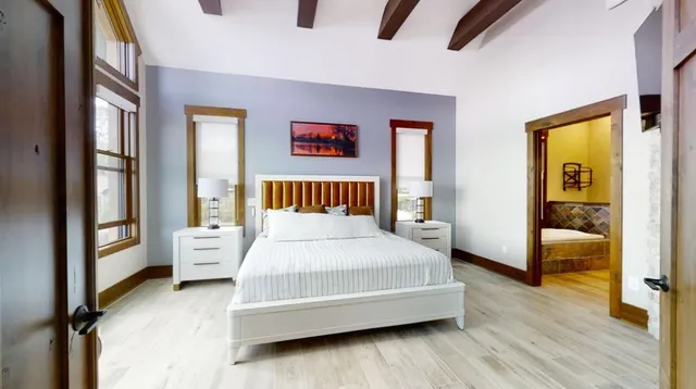 a bed sitting in a bedroom next to a window