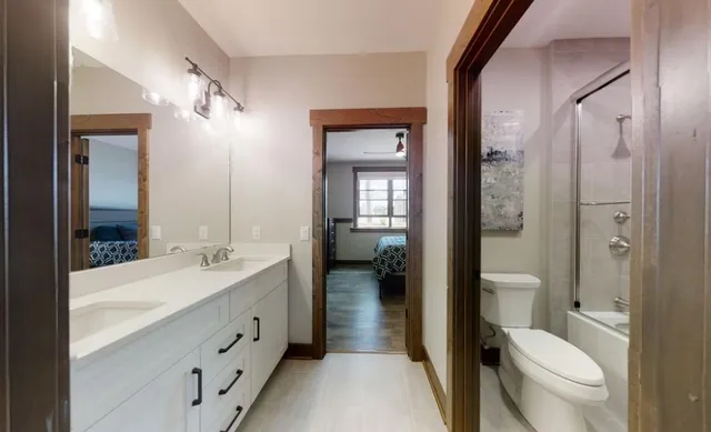 a bathroom with a toilet a sink and shower