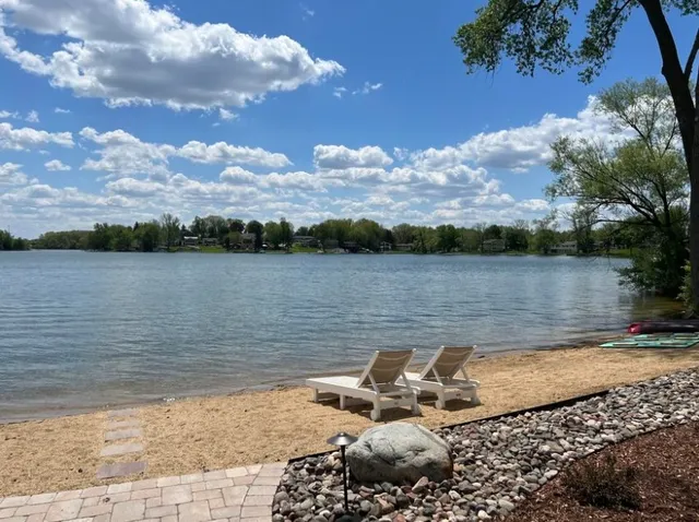 a kitchen with counter top space a sink appliances and cabinets