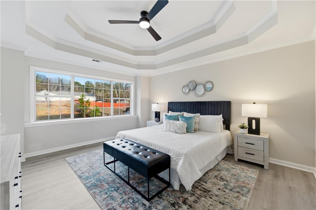 3363 Old Oaks Road Buford, GA 30519 - Photo 11 of 29 a bedroom with a bed wooden floor and window