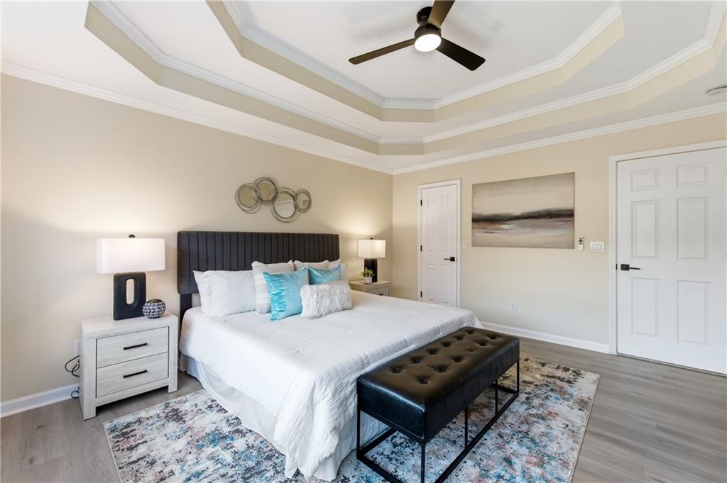 3363 Old Oaks Road Buford, GA 30519 - Photo 12 of 29 a bedroom with a bed and wooden floor