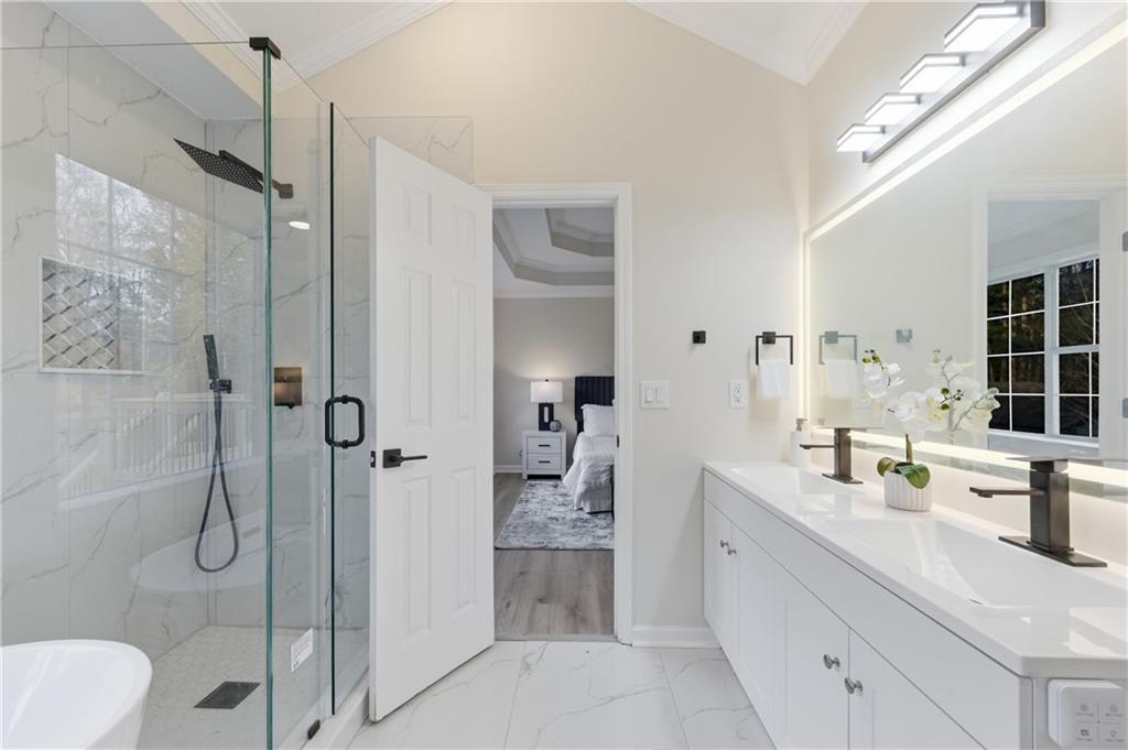 3363 Old Oaks Road Buford, GA 30519 - Photo 13 of 29 a en suite bathroom with a granite countertop sink a toilet and shower