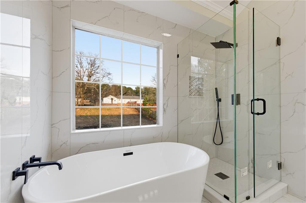 3363 Old Oaks Road Buford, GA 30519 - Photo 15 of 29 a white bath tub sitting next to a shower