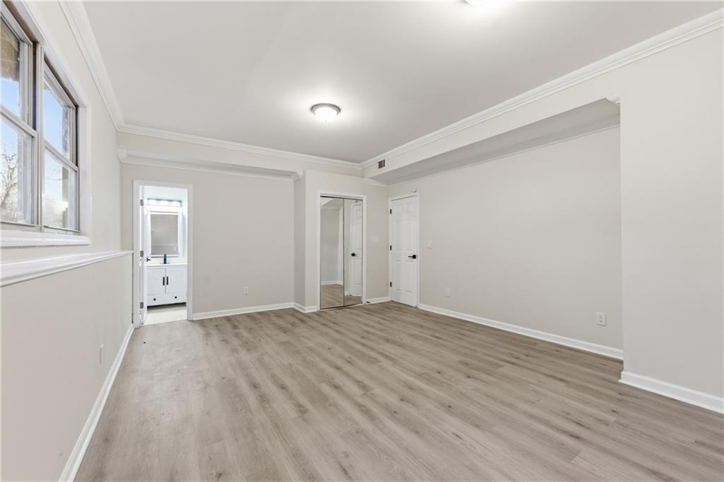 3363 Old Oaks Road Buford, GA 30519 - Photo 18 of 29 wooden floor in an empty room with a window