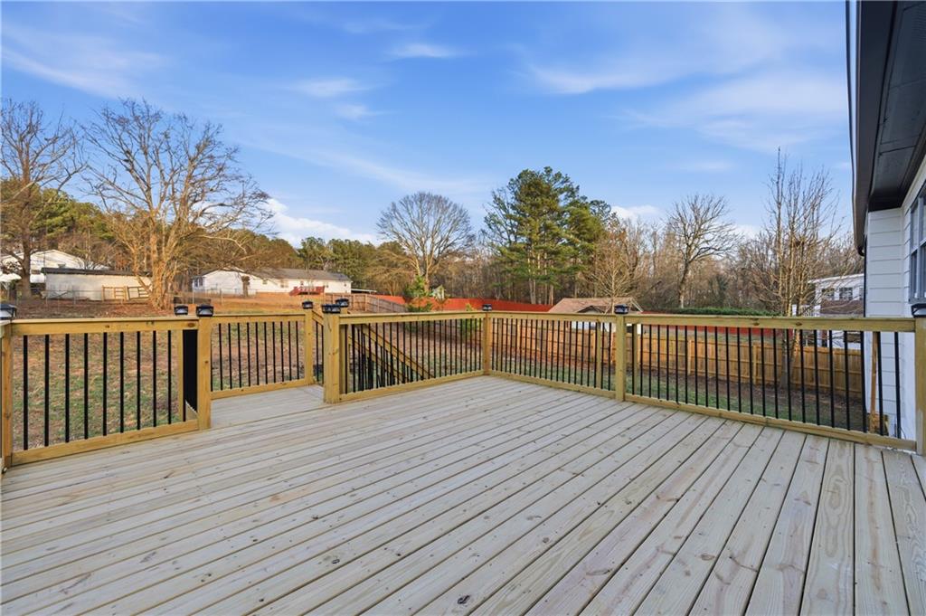 3363 Old Oaks Road Buford, GA 30519 - Photo 24 of 29 a view of a balcony with wooden floor and fence