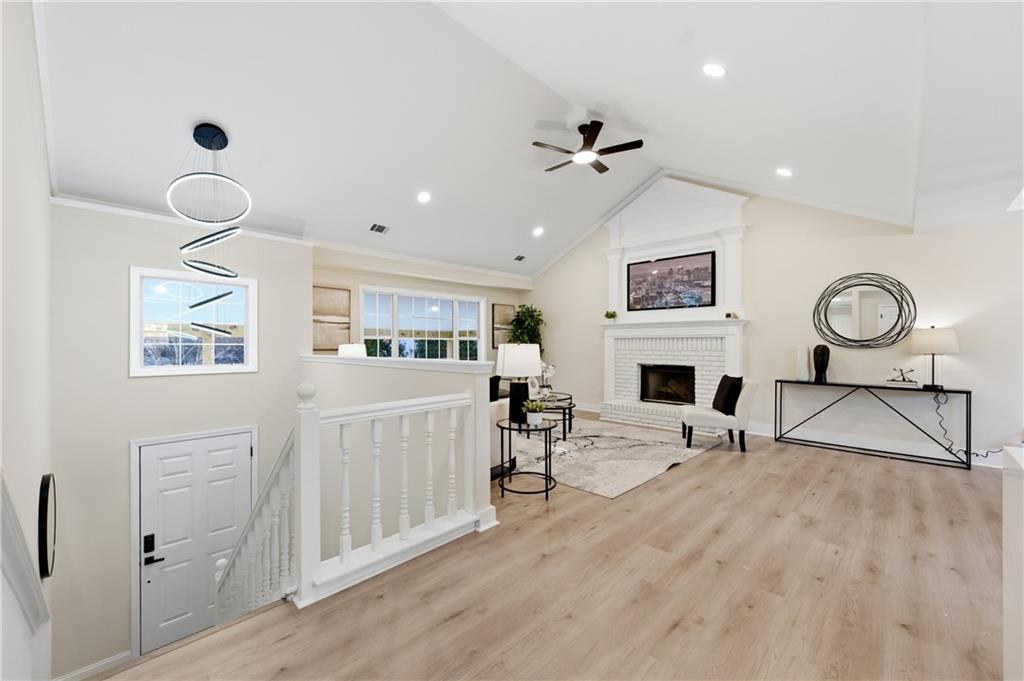 3363 Old Oaks Road Buford, GA 30519 - Photo 5 of 29 a living room with furniture a fireplace and a flat screen tv