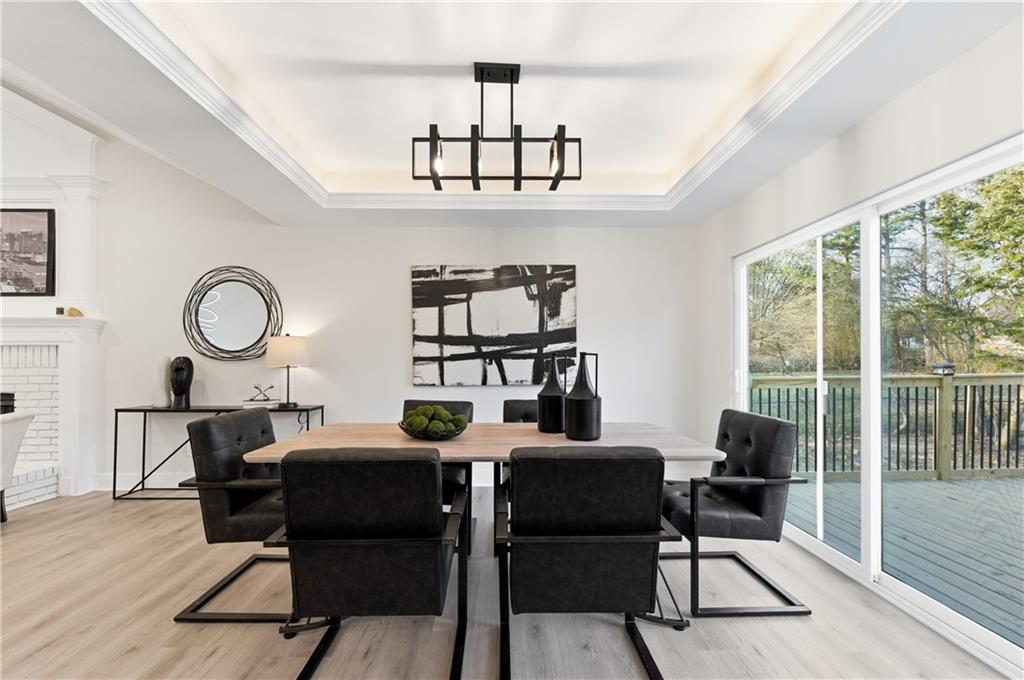 3363 Old Oaks Road Buford, GA 30519 - Photo 7 of 29 a view of a dining room with furniture a chandelier and wooden floor