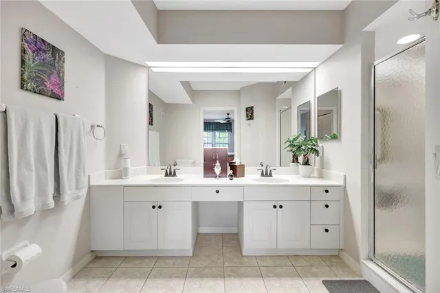 a spacious bathroom with a double vanity sink and a mirror