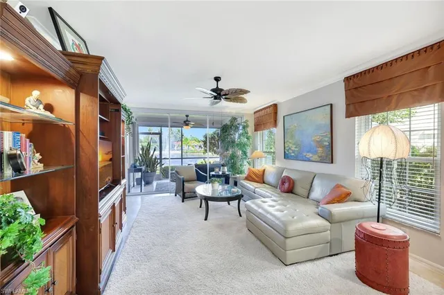 a living room with furniture a fireplace and a large window