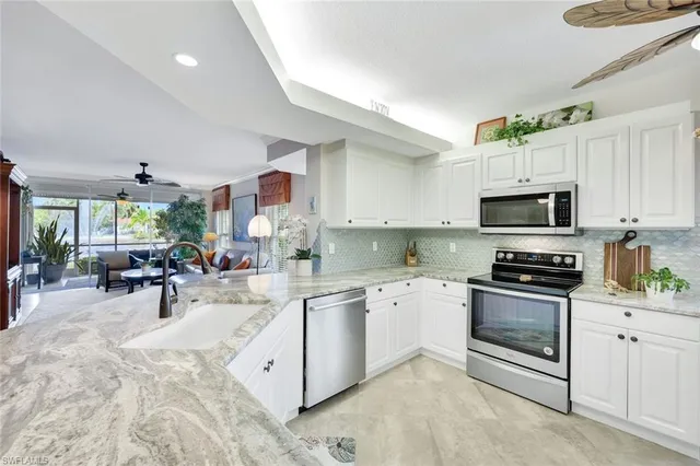 a kitchen with microwave a stove and cabinets