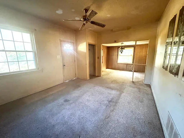 wooden floor in an empty room with a window