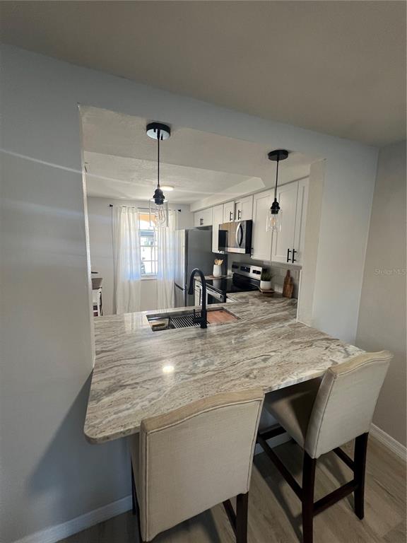 4117 Hampton Drive New Port Richey, FL 34652 - Photo 4 of 23 a view of dining table chairs and chandelier