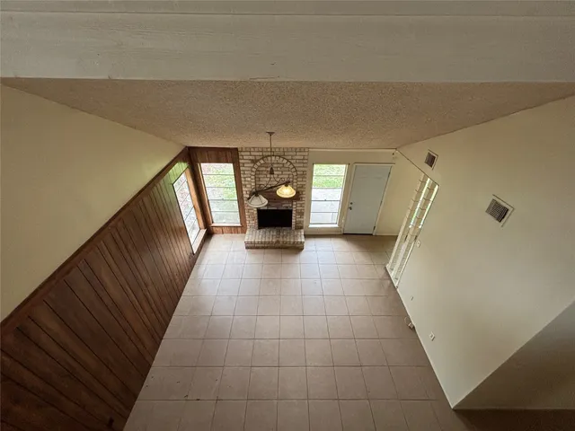a view of an empty room with a fireplace