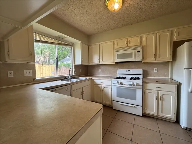 a kitchen with a stove sink and refrigerator