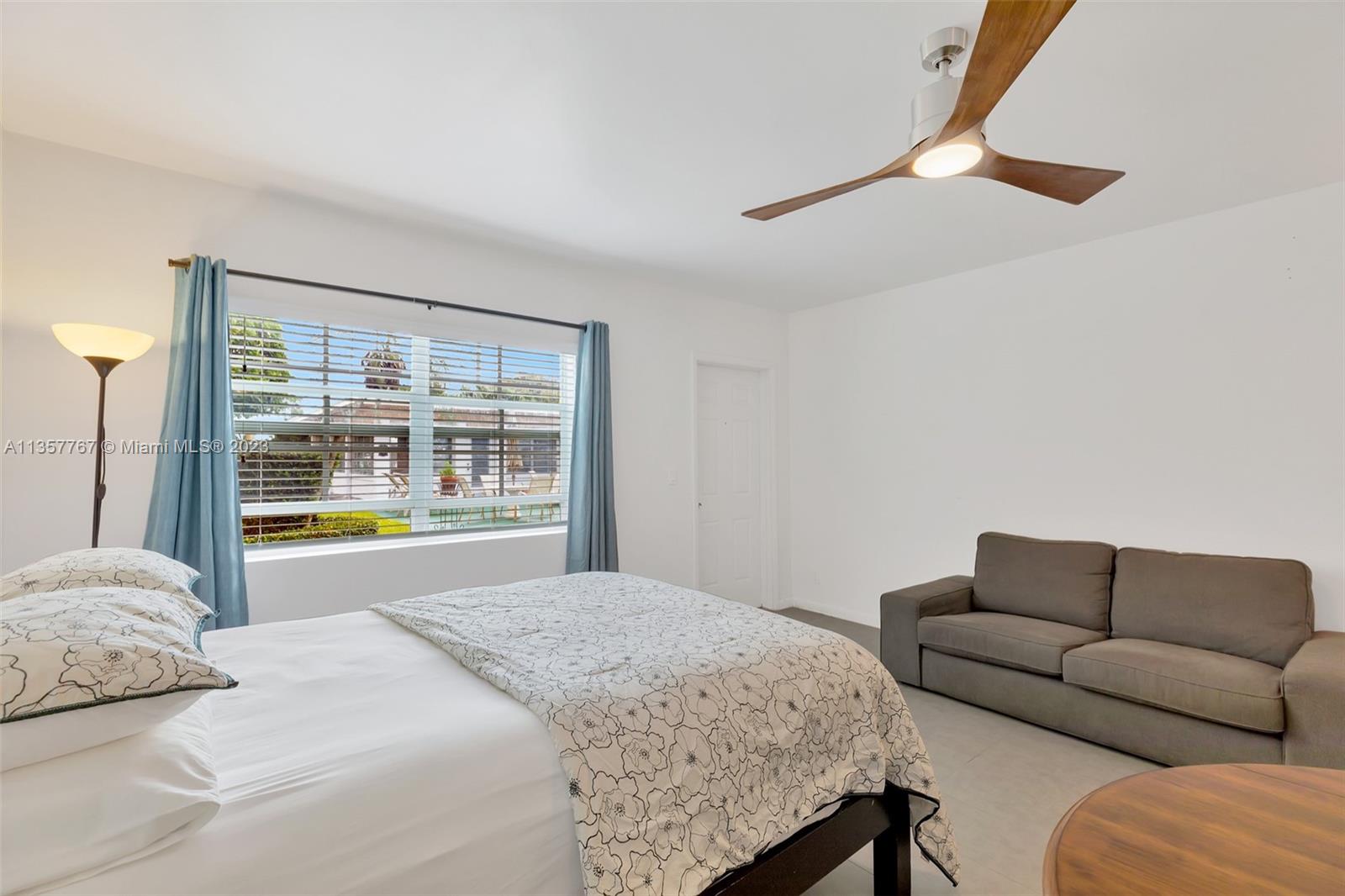 31 South Golfview Road, Unit 2 Lake Worth, FL 33460 - Photo 2 of 18 a bedroom with a bed couch and window