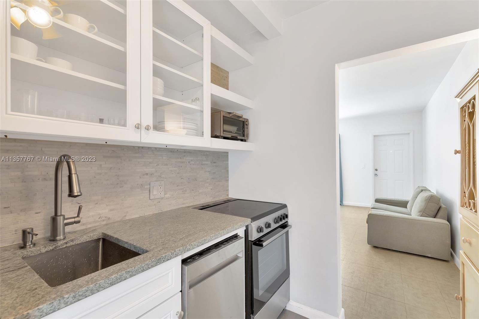 31 South Golfview Road, Unit 2 Lake Worth, FL 33460 - Photo 3 of 18 a kitchen with a sink and a refrigerator