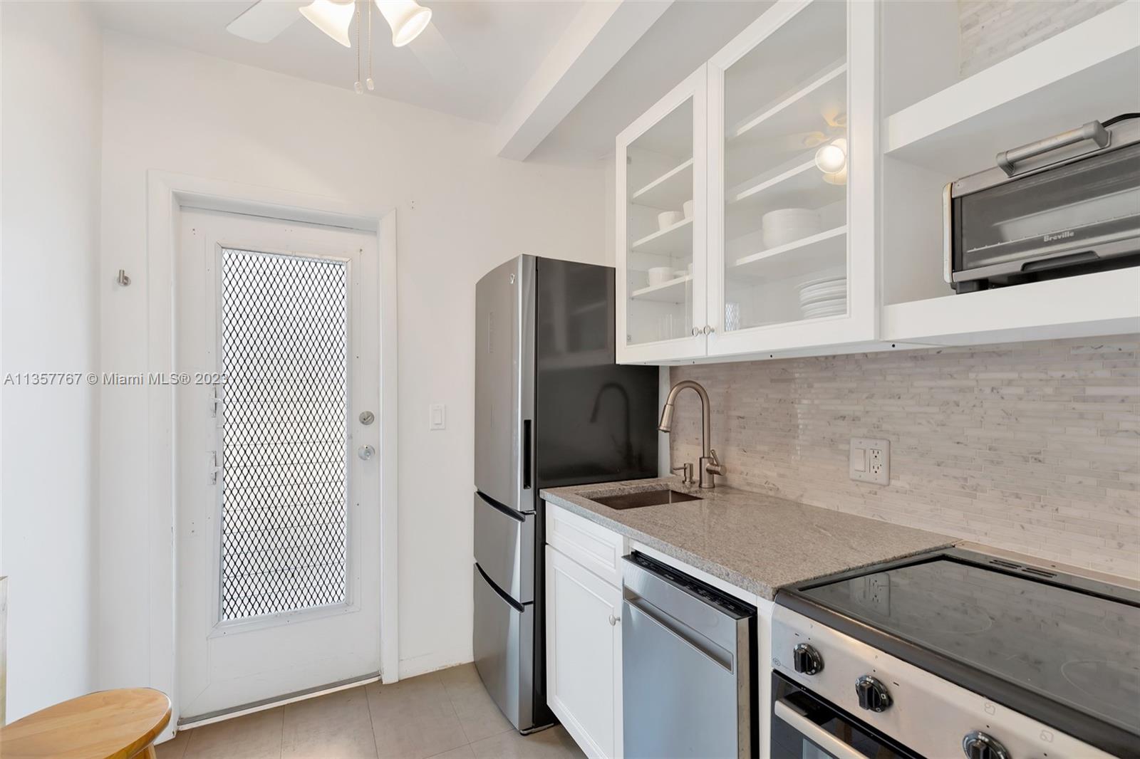 31 South Golfview Road, Unit 2 Lake Worth, FL 33460 - Photo 4 of 18 a kitchen with stainless steel appliances granite countertop a refrigerator and a stove