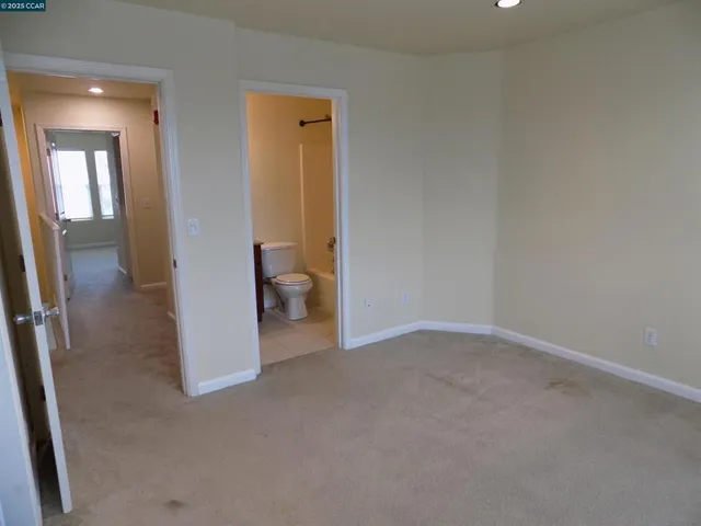 a view of a hallway with wooden floor and entryway