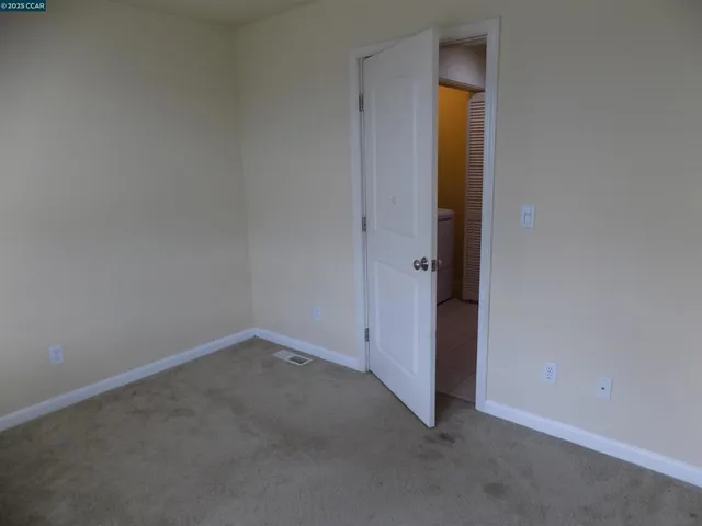 an empty room with closet and closet