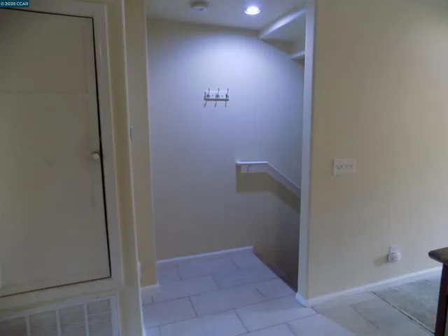 a view of walk in closet with empty racks