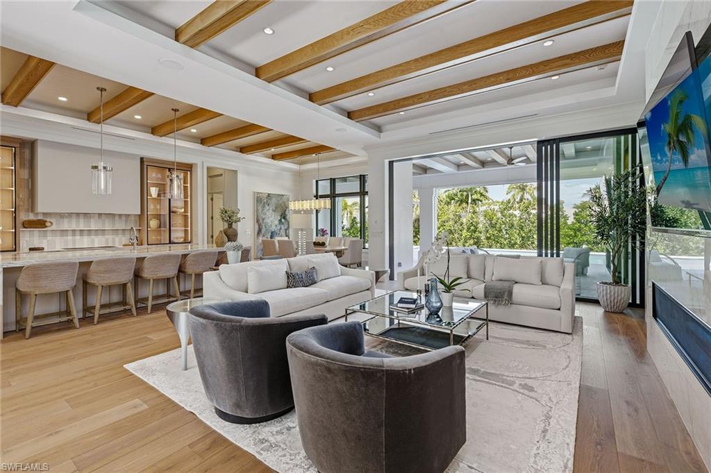 529 Neapolitan Way Naples, FL 34103 - Photo 3 of 26 a living room with furniture and a large window