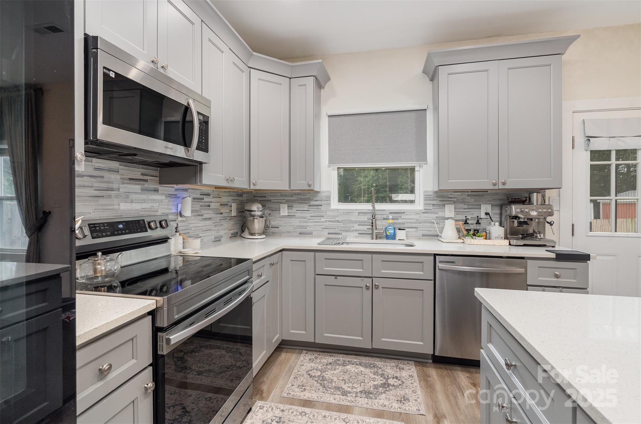1052 McLain Road Kannapolis, NC 28083 - Photo 13 of 30 a kitchen with a sink stove and microwave