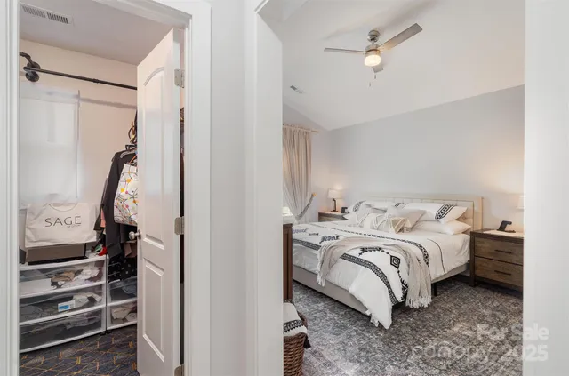 a view of a bedroom with bed and wooden floor