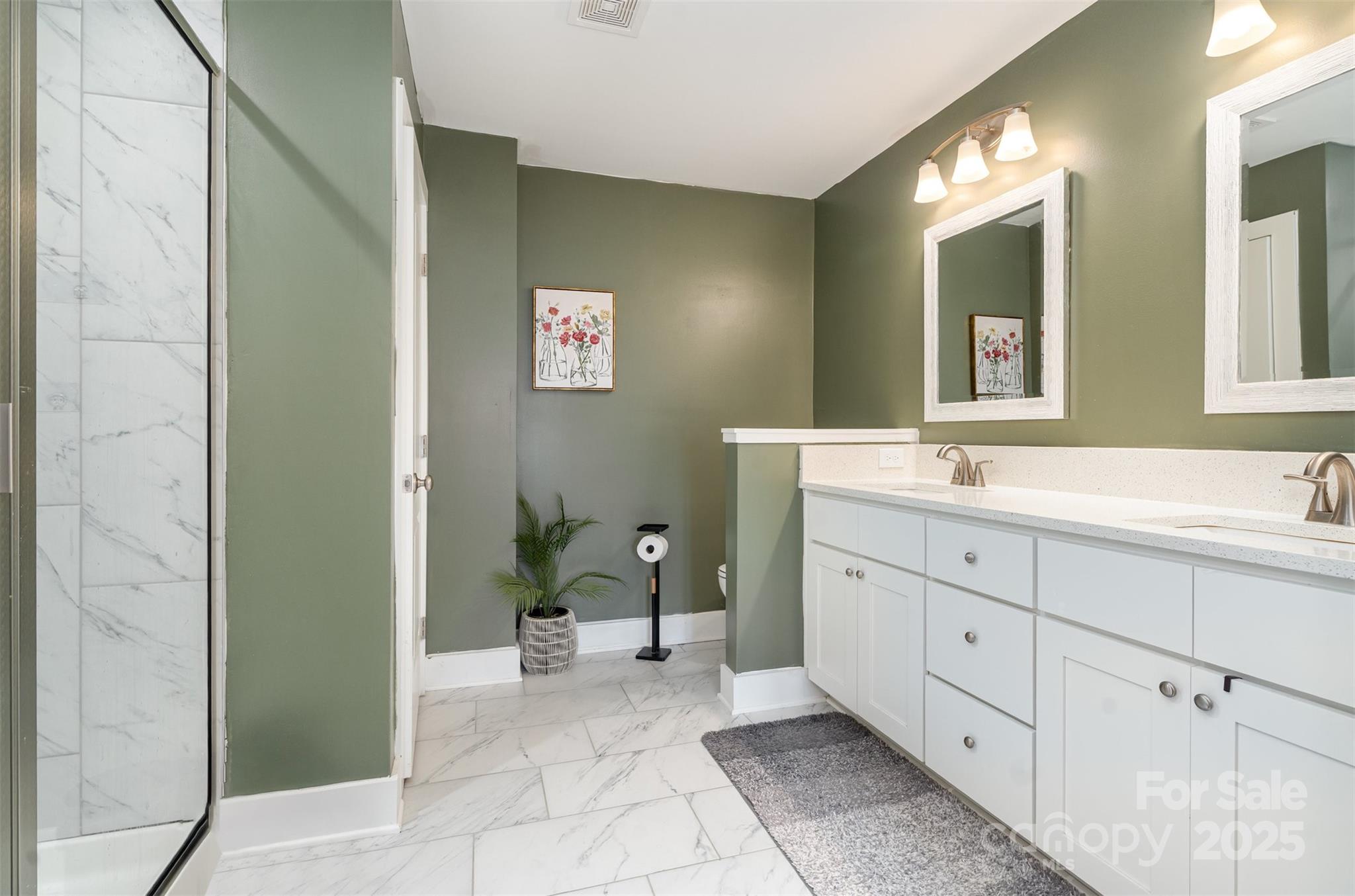 1052 McLain Road Kannapolis, NC 28083 - Photo 23 of 30 a spacious bathroom with a double vanity sink a mirror and a