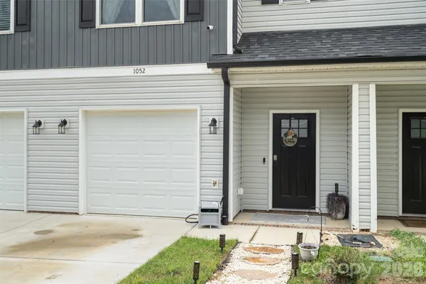 a living room with furniture and a view of kitchen