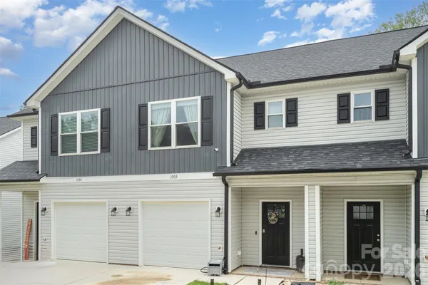 a living room with furniture and a dining table with wooden floor