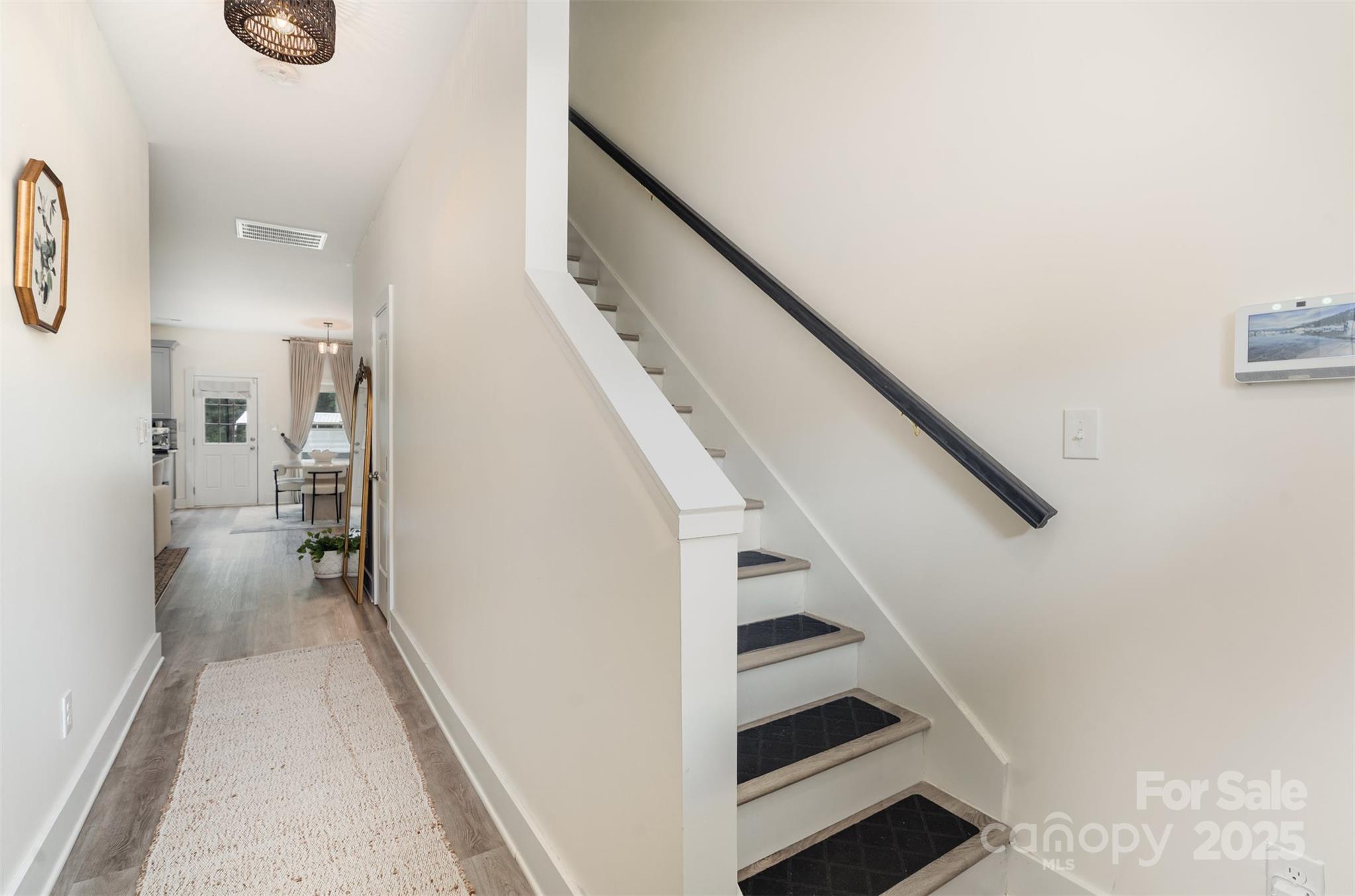 1052 McLain Road Kannapolis, NC 28083 - Photo 6 of 30 a view of hallway with stairs and wooden floor