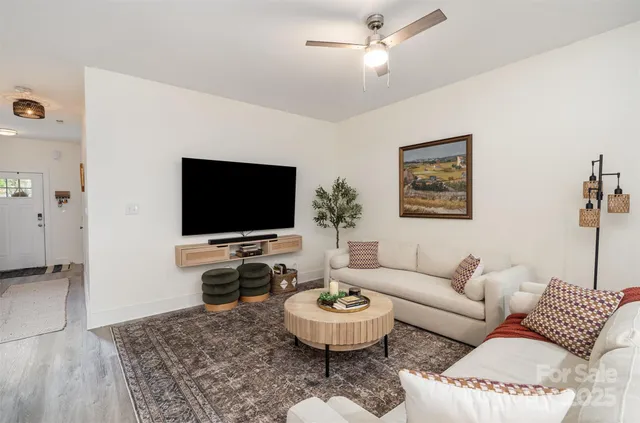 a living room with furniture and a flat screen tv