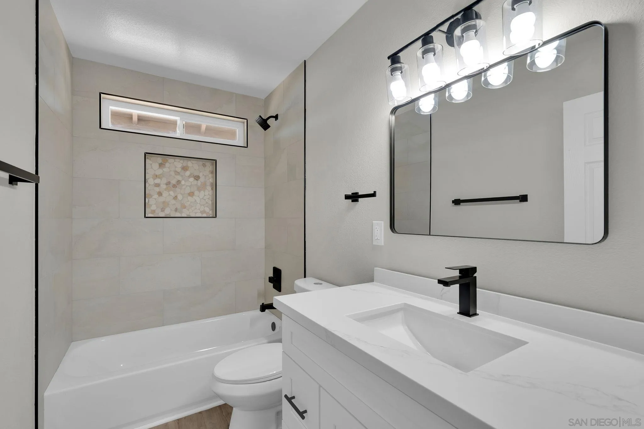 13322 Via Mark Poway, CA 92064 - Photo 19 of 25 a bathroom with a sink a toilet a mirror a vanity and bathtub
