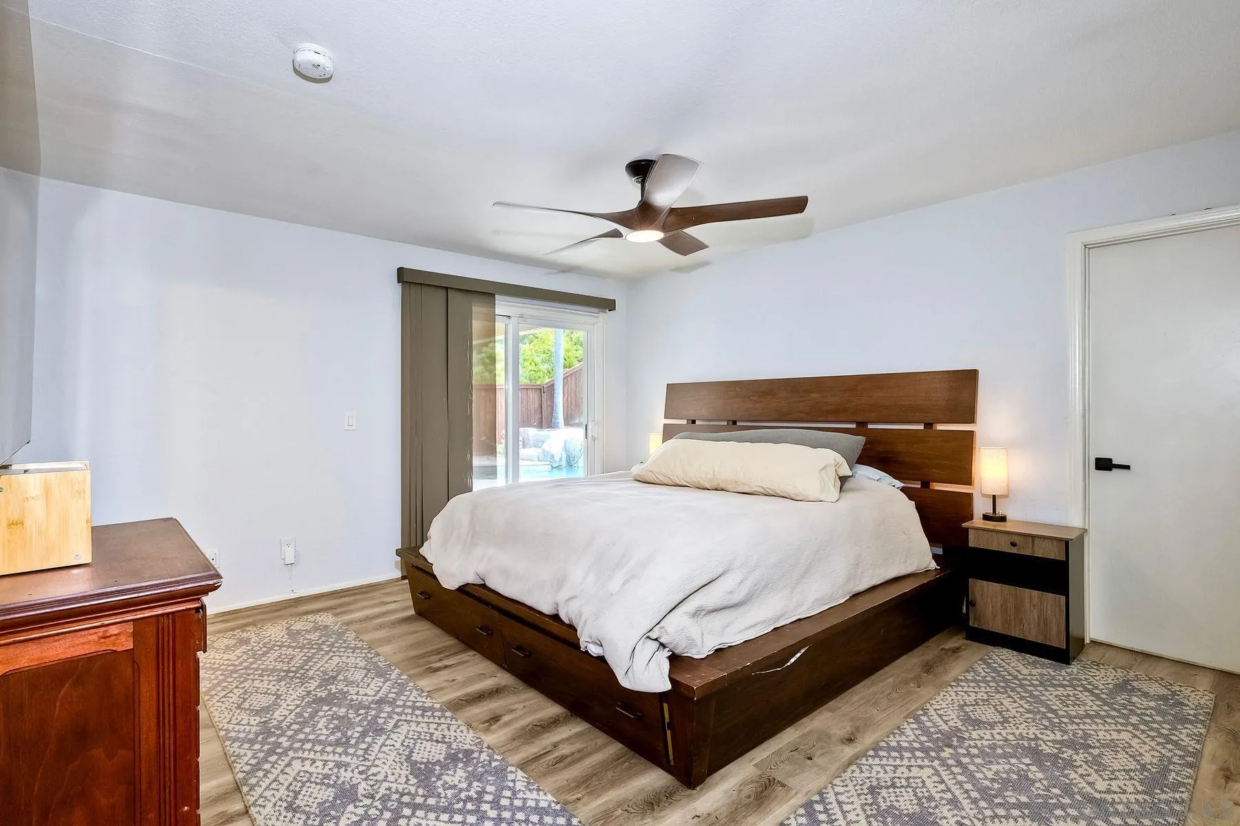 3511 Sitio Baya Carlsbad, CA 92009 - Photo 18 of 42 a bedroom with a bed and wooden floor