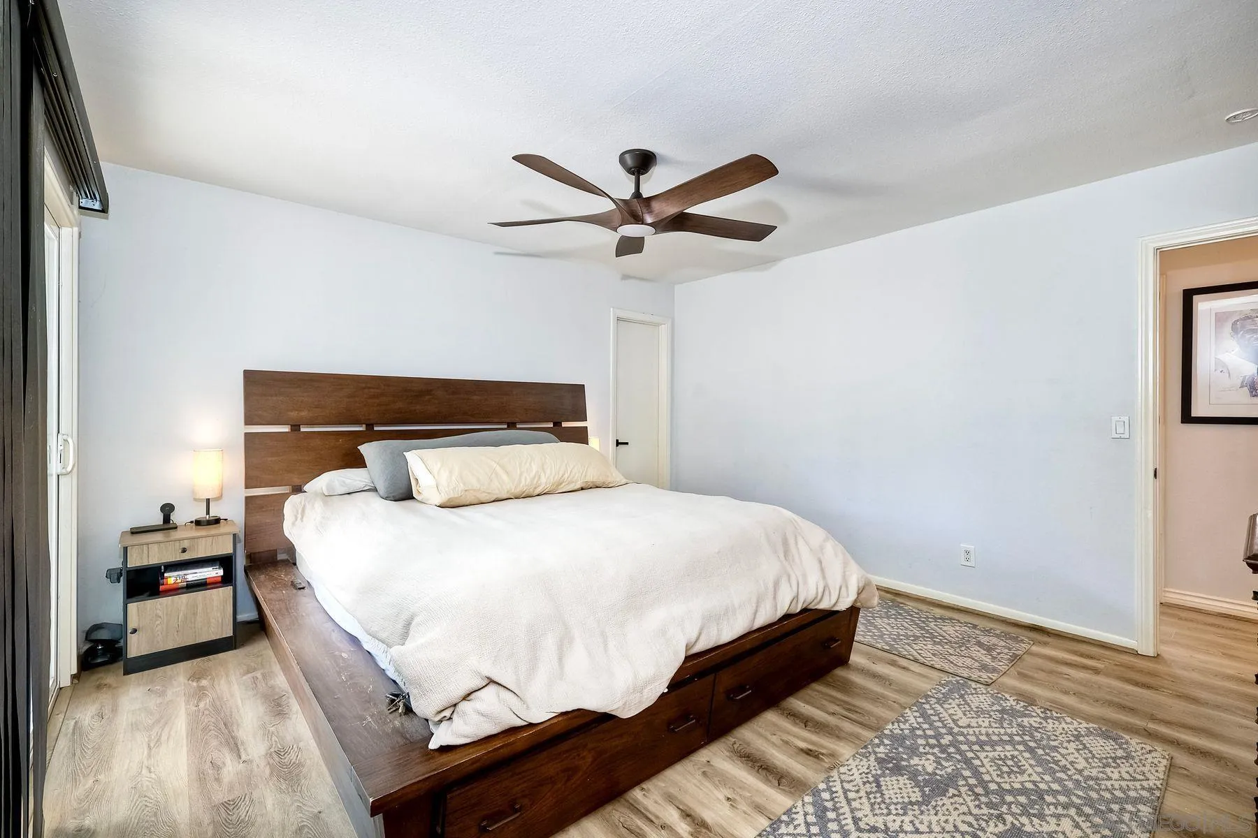 3511 Sitio Baya Carlsbad, CA 92009 - Photo 19 of 42 a bedroom with a bed and a chandelier