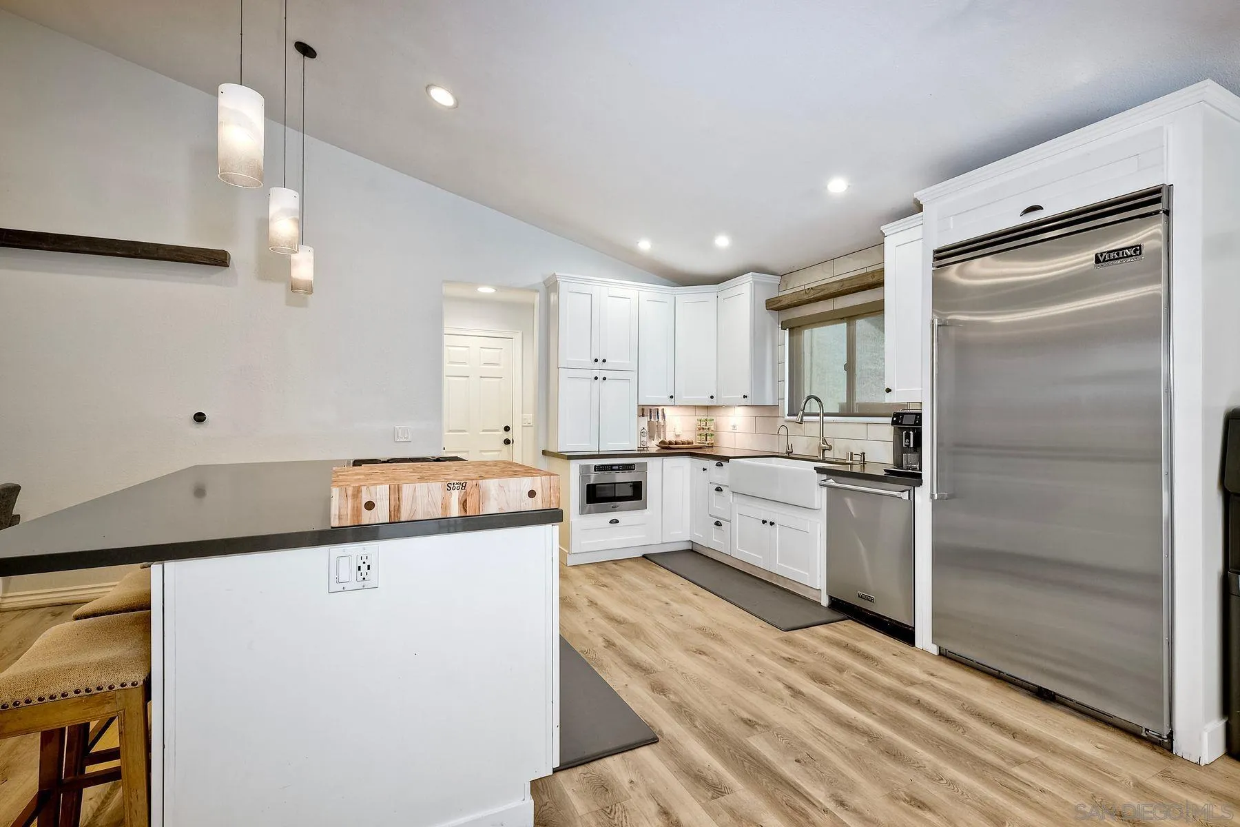 3511 Sitio Baya Carlsbad, CA 92009 - Photo 10 of 42 a kitchen with granite countertop a refrigerator sink stove and oven